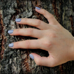 hand on a tree grey nails